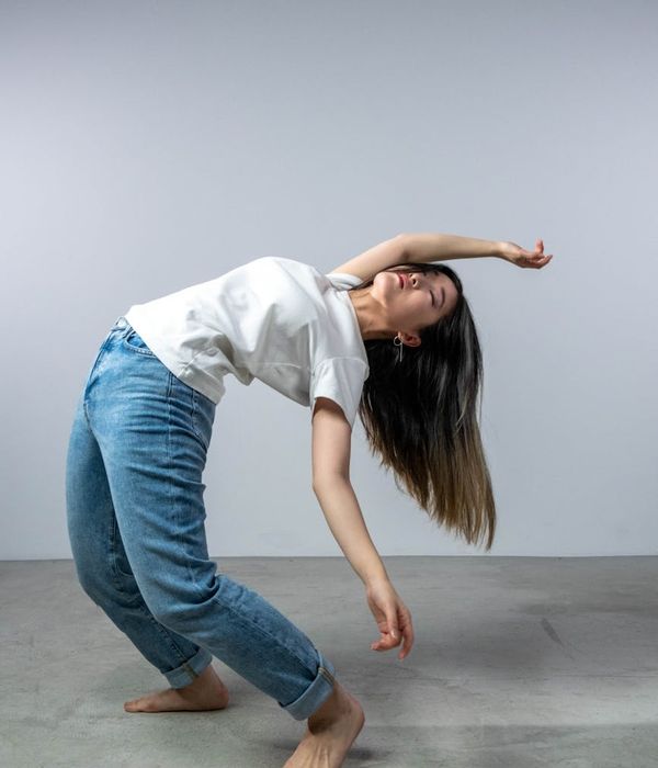 Woman stretching gracefully, feeling renewed energy and flexibility.